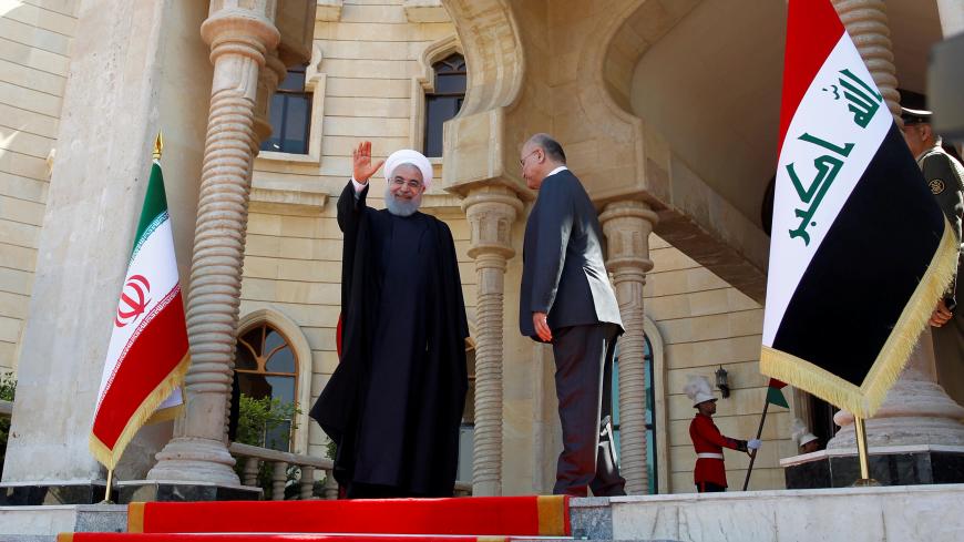 Iranian President Hassan Rouhani waves his hand during a welcome ceremony at Salam Palace in Baghdad, Iraq March 11, 2019. REUTERS/Khalid al-Mousily - RC1D812E2710