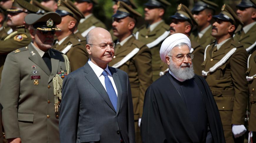 Iraq's President Barham Salih walks with Iranian President Hassan Rouhani during a welcome ceremony at Salam Palace in Baghdad, Iraq March 11, 2019. REUTERS/Thaier al-Sudani - RC1EE48851F0
