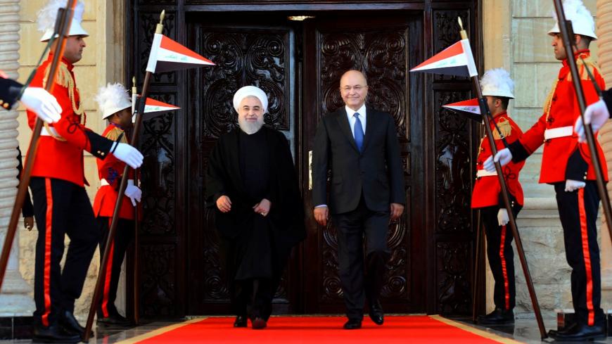 Iraq's President Barham Salih walks with Iranian President Hassan Rouhani during a welcome ceremony at Salam Palace in Baghdad, Iraq, March 11, 2019. The Presidency of the Republic of Iraq Office/Handout via REUTERS   ATTENTION EDITORS - THIS IMAGE WAS PROVIDED BY A THIRD PARTY. - RC14E2C02AD0