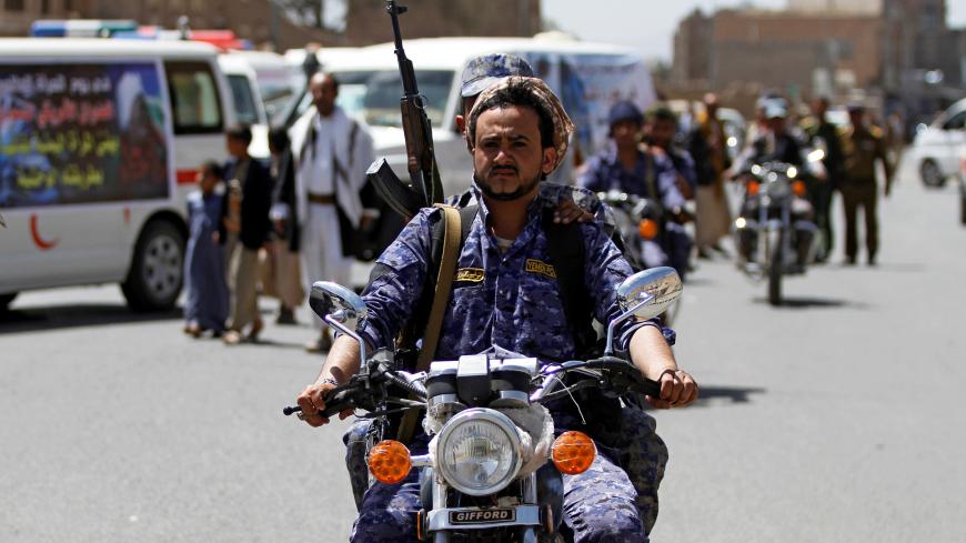 A Houthi security officer rides a motorbike during a funeral of people killed by an air strike last week in the northwestern province of Hajja, in Sanaa, Yemen March 14, 2019. REUTERS/Mohamed al-Sayaghi - RC1B7ACE3330
