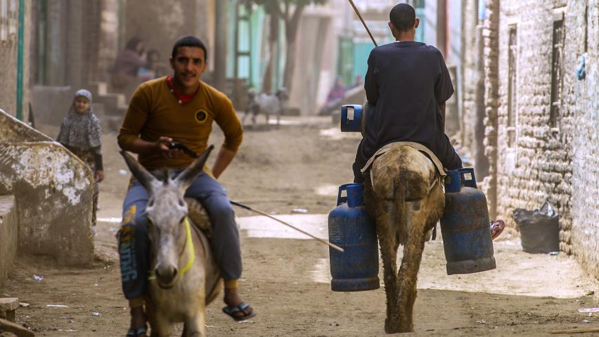 An Egyptian man carries gas canisters on his donkey in the village of al-Jendyaa, in the Bani Mazar  province, in Minya governorate south of Cairo, on April 5, 2016.  / AFP / KHALED DESOUKI        (Photo credit should read KHALED DESOUKI/AFP/Getty Images)