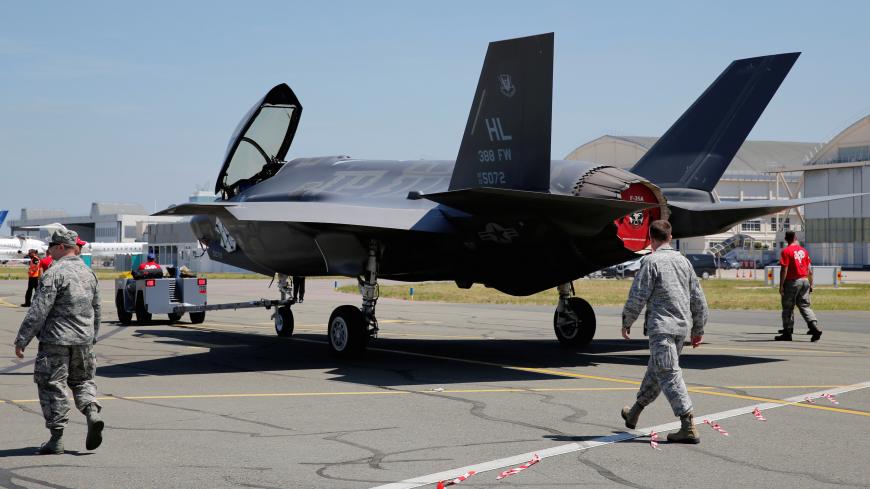 U.S. airmen walk next to a Lockheed Martin F-35 Lightning II aircraft, as it is moved, on the eve of the 52nd Paris Air Show at Le Bourget Airport near Paris, France June 18, 2017. REUTERS/Pascal Rossignol - RC15E3E8E180