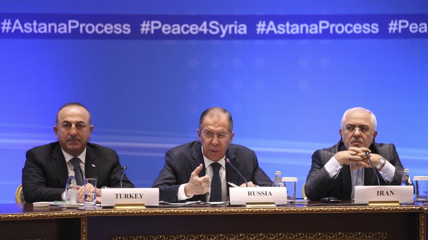 Foreign Ministers, Sergei Lavrov (C) of Russia, Mevlut Cavusoglu (L) of Turkey and Mohammad Javad Zarif of Iran, attend the international meeting on Syria in Astana, Kazakhstan March 16, 2018. REUTERS/Mukhtar Kholdorbekov - UP1EE3G0MWO1V