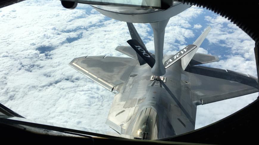 One of two U.S. Air Force F-22 stealth fighter jets receives fuel mid-air from a KC-135 refueling plane over Norway en route to a joint training exercise with Norway's growing fleet of F-35 jets August 15, 2018.  REUTERS/Andrea Shalal - RC188F5E88B0