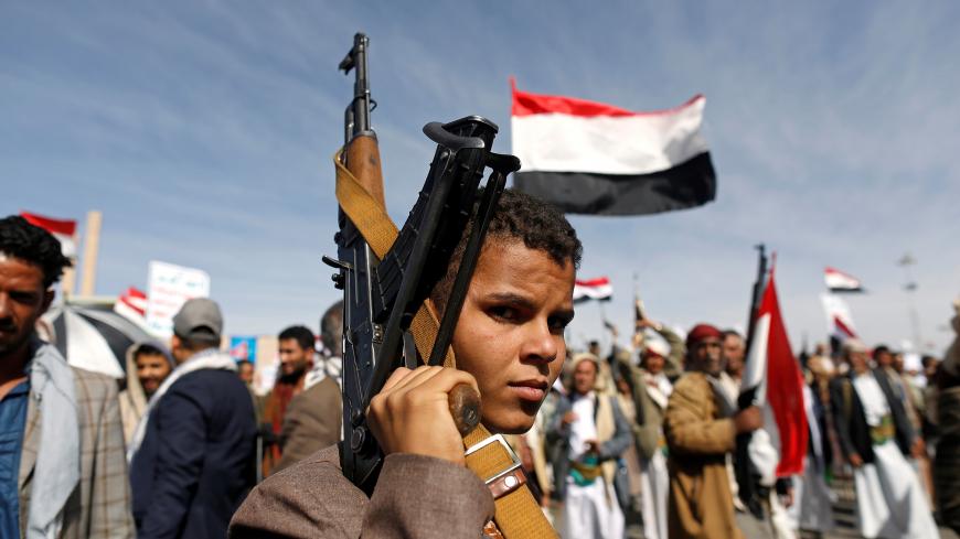 A supporter of the Houthi movement looks as he holds up a rifle during a rally to mark the 4th anniversary of the Saudi-led military intervention in Yemen's war, in Sanaa, Yemen March 26, 2019. REUTERS/Khaled Abdullah - RC1A7AFBD220