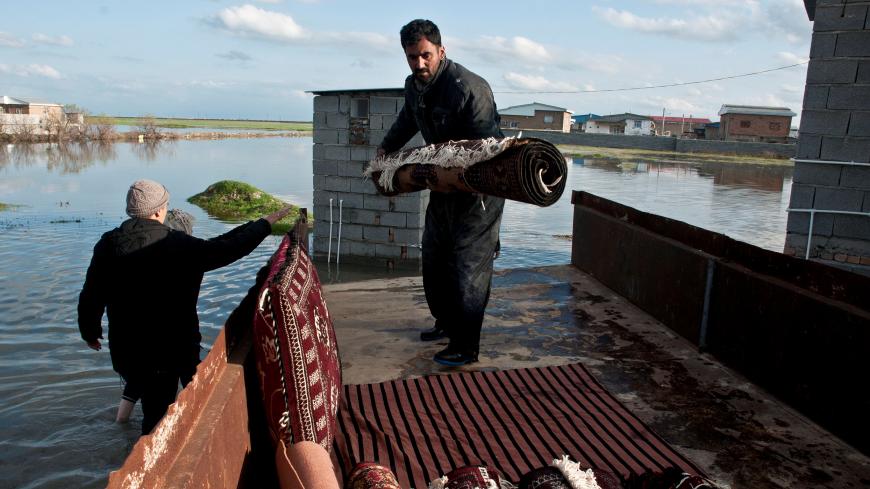 A man carries his belongings after flooding in Mazandaran province, Iran, March 22, 2019. Picture taken March 22, 2019. Tasnim News Agency/via REUTERS ATTENTION EDITORS - THIS PICTURE WAS PROVIDED BY A THIRD PARTY - RC189B129D80