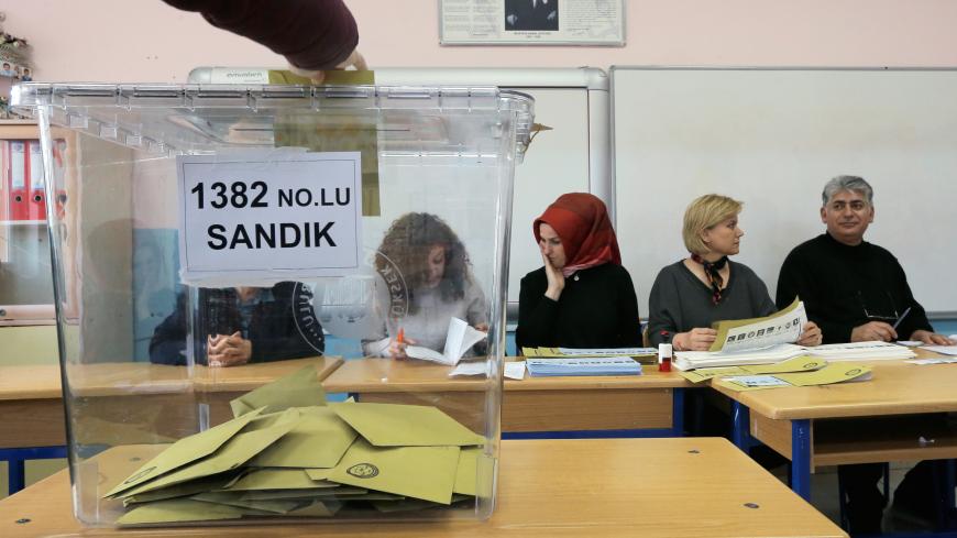 A voter casts a ballot at a polling station during the municipal elections in Istanbul, Turkey, March 31, 2019. REUTERS/Huseyin Aldemir - RC1927A46580