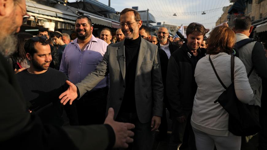 Moshe Feiglin, leader of Zehut, an ultra-nationalist religious party, greets people as he campaigns ahead of elections at Mahane Yehuda market in Jerusalem April 4, 2019. REUTERS/Ammar Awad - RC170794A5E0