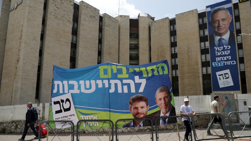 A Right Wing Union election campaign banner depicting Rabbi Rafi Peretz and Betzalel Smotrich is seen near a Benny Gantz's Blue and White party election campaign banner in Jerusalem April 7, 2019. REUTERS/Ammar Awad - RC1790A47480