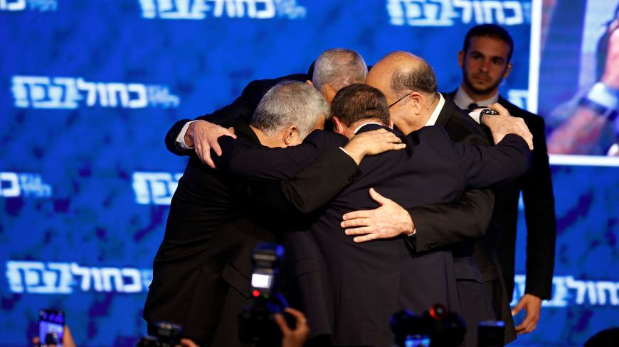 Benny Gantz, head of Blue and White party, huddles with his party candidates Yair Lapid, Moshe Yaalon and Gaby Ashkenazi, following the announcement of exit polls in Israel's parliamentary election at the party headquarters in Tel Aviv, Israel April 10, 2019. REUTERS/Amir Cohen - RC11ADB5E0C0