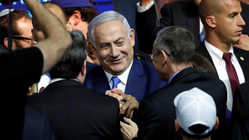 Israeli Prime Minister Benjamin Netanyahu is greeted by supporters of his Likud party as he arrives to speak following the announcement of exit polls in Israel's parliamentary election at the party headquarters in Tel Aviv, Israel April 10, 2019. REUTERS/Ronen Zvulun - RC142FAD5F40