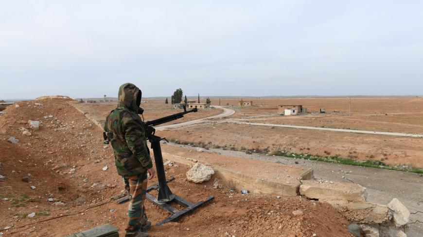 A Syrian Army soldier loyal to Syria's President Bashar al-Assad forces stands next to a military weapon in Idlib, Syria January 21, 2018. Picture taken January 21, 2018. SANA/Handout via REUTERS ATTENTION EDITORS - THIS PICTURE WAS PROVIDED BY A THIRD PARTY. REUTERS IS UNABLE TO INDEPENDENTLY VERIFY THE AUTHENTICITY, CONTENT, LOCATION OR DATE OF THIS IMAGE. - RC19C0D8B740