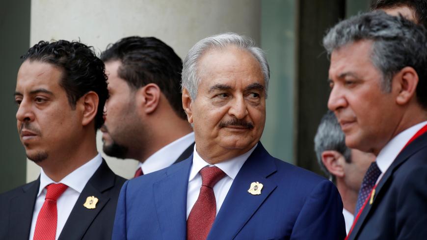 Khalifa Haftar (C), the military commander who dominates eastern Libya, leaves after an international conference on Libya at the Elysee Palace in Paris, France, May 29, 2018.  REUTERS/Philippe Wojazer - RC1C86F2EC00