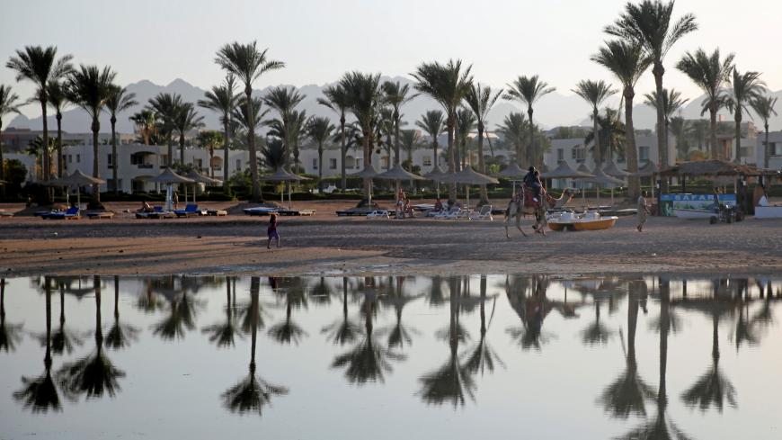 Tourists are seen on a beach at the Sinai Peninsula, the Gulf of Aqaba, Egypt July 12, 2018. Picture taken July 12, 2018. REUTERS/Amr Abdallah Dalsh - RC16DE463370