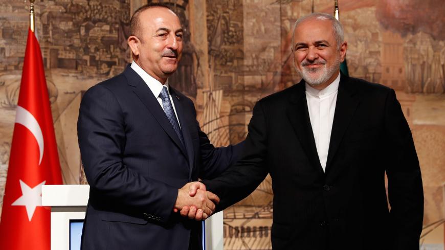 Turkish Foreign Minister Mevlut Cavusoglu shakes hands with his Iranian counterpart Javad Zarif during a news conference in Istanbul, Turkey October 30, 2018. REUTERS/Murad Sezer - RC15CF69EA60