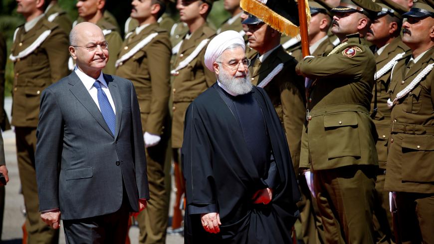 Iraq's President Barham Salih walks with Iranian President Hassan Rouhani during a welcome ceremony at Salam Palace in Baghdad, Iraq March 11, 2019. REUTERS/Thaier al-Sudani - RC1C55FF7D70