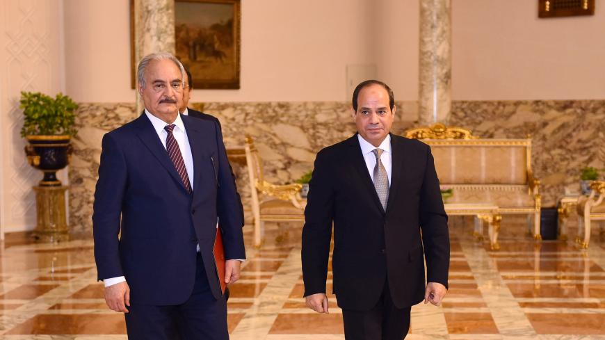 Libyan military commander Khalifa Haftar walks with Egyptian President Abdel Fattah al-Sisi at the Presidential Palace in Cairo, Egypt April 14, 2019 in this handout picture courtesy of the Egyptian Presidency. The Egyptian Presidency/Handout via REUTERS ATTENTION EDITORS - THIS IMAGE WAS PROVIDED BY A THIRD PARTY. - RC1F3D59FD40