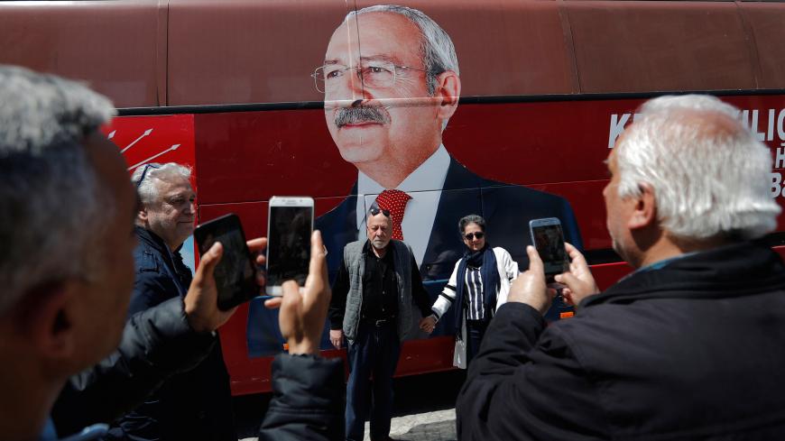 Supporters of the main opposition Republican People's Party (CHP) pose in front of a party bus with a picture of their leader Kemal Kilicdaroglu on it, in Istanbul, Turkey, April 22, 2019. REUTERS/Murad Sezer - RC1772ED6760
