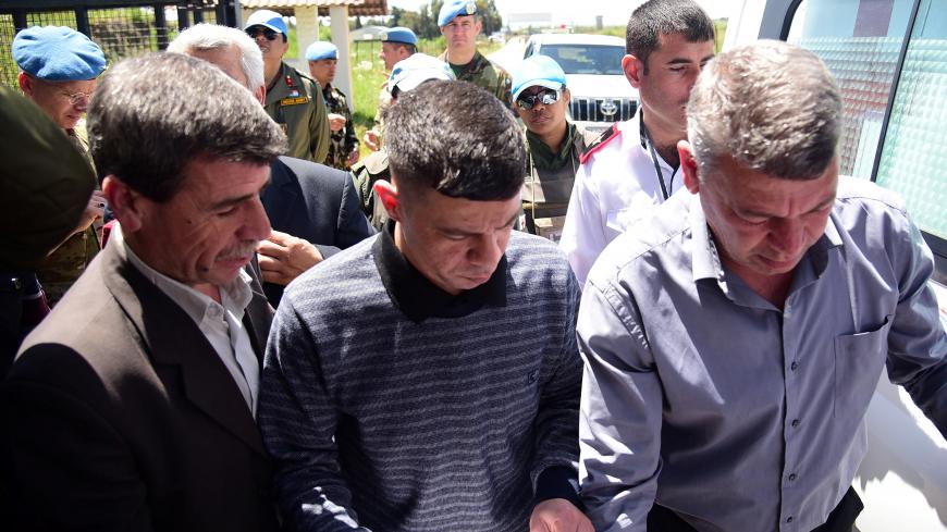 A freed prisoner is seen after he was released by Israel in what Damascus described as Russian-mediated reciprocation for the repatriation of the body of a long-missing Israeli soldier, at the Quneitra crossing, Syria, in this handout released by SANA on April 28, 2019. SANA/Handout via REUTERS ATTENTION EDITORS - THIS IMAGE WAS PROVIDED BY A THIRD PARTY. REUTERS IS UNABLE TO INDEPENDENTLY VERIFY THIS IMAGE - RC1435271320