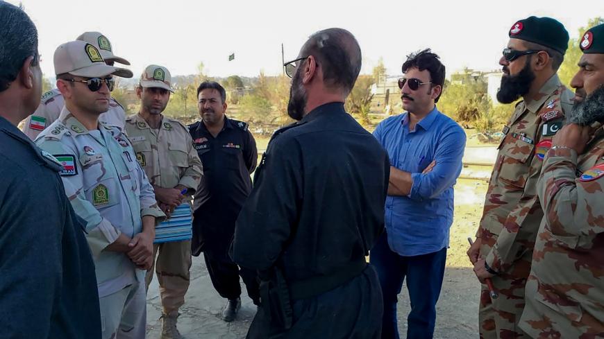 In this picture taken on April 21, 2019, Pakistani border security officials (R) and Iranian border security officials (L) meet at Zero Point at the Pakistan-Iran border in Taftan. - Iran and Pakistan have agreed to set up a joint border "reaction force" following a number of deadly attacks by militant groups on their frontier, Iranian President Hassan Rouhani announced April 22 after talks with visiting Pakistani Prime Minister Imran Khan. (Photo by STR / AFP)        (Photo credit should read STR/AFP/Getty