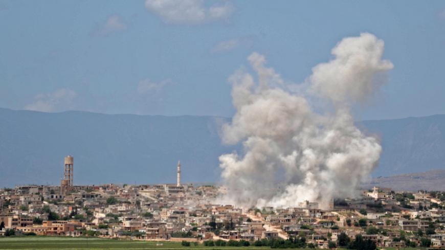 Smoke billows above building during reported shelling by government and allied forces, in the town of Hbeit in the southern countryside of the rebel-held Idlib province on May 3,2019. (Photo by OMAR HAJ KADOUR / AFP)        (Photo credit should read OMAR HAJ KADOUR/AFP/Getty Images)