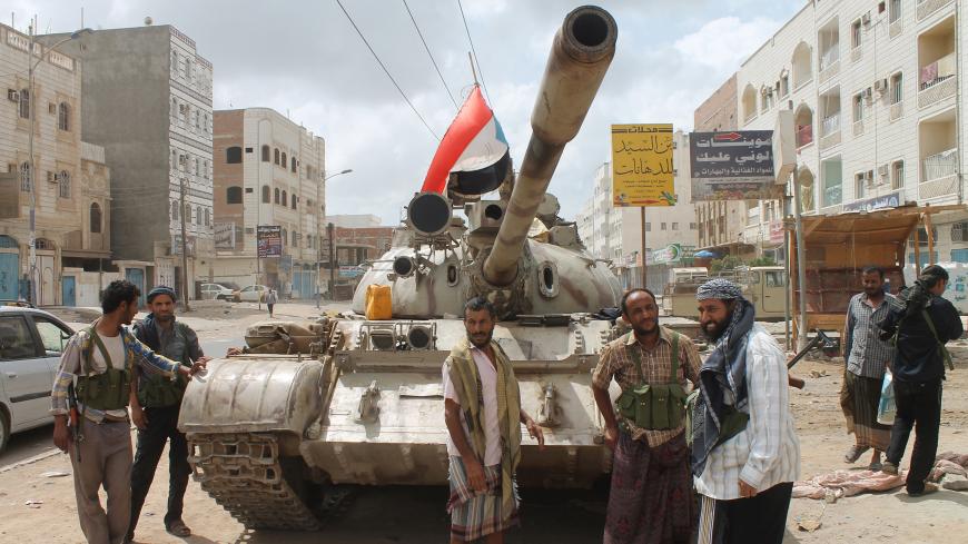 Yemeni members of the southern separatist movement, loyal to President Abedrabbo Mansour Hadi, stand next to a tank on April 15, 2015 in Aden's northern suburbs. Saudi-led coalition air strikes hit rebel targets in the Yemen's main southern city after overnight attacks by anti-government forces killed seven people, military sources and medics said. AFP PHOTO /  SALEH AL-OBEIDI        (Photo credit should read SALEH AL-OBEIDI/AFP/Getty Images)