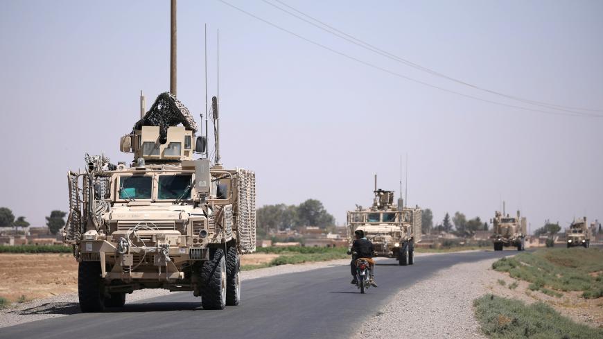 A U.S military convoy is seen on the main road in Raqqa, Syria July 31, 2017. REUTERS/ Rodi Said - RC1664C87120