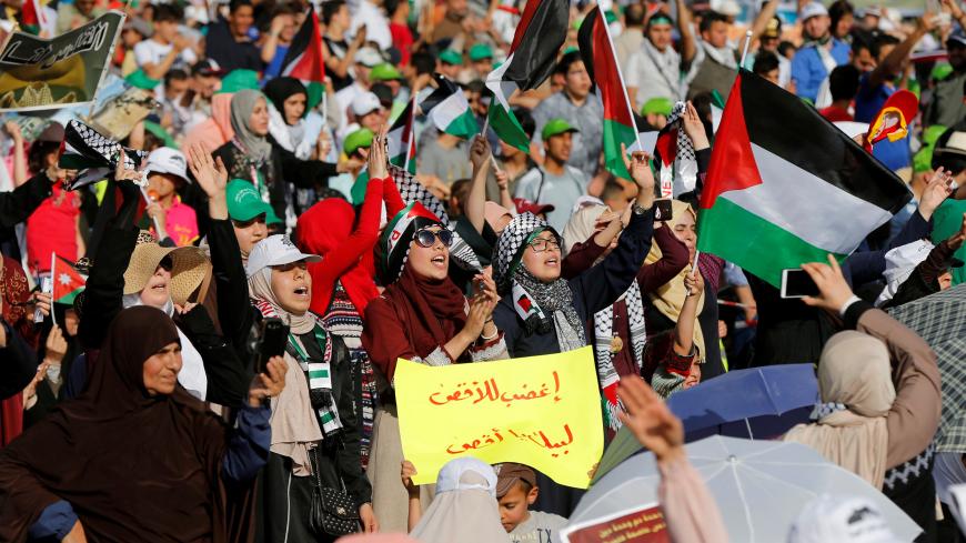 Supporters of Jordanian Muslim Brotherhood and Islamic Action Front party hold Palestinian flags and shout slogans during a rally to mark the 70th anniversary of Nakba in the Jordan Valley, Sweimeh, Jordan May 11, 2018. REUTERS/Muhammad Hamed - RC1D09C32540