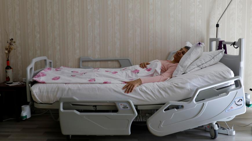 Leyla Guven, pro-Kurdish Peoples' Democratic Party (HDP) lawmaker who has been on a hunger strike for more than four months, rests in her bed at her home in Diyarbakir, Turkey, March 20, 2019. Picture taken March 20, 2019. REUTERS/Umit Bektas - RC1F50CE4990