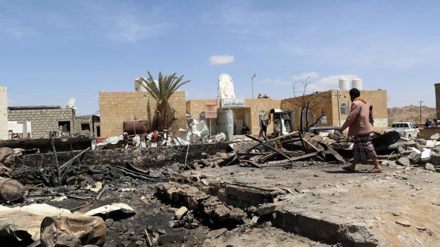 A man walks at the scene of an air strike that hit a gas station near a hospital in Kutaf district of the northwestern province of Saada, Yemen March 28, 2019. REUTERS/Naif Rahma - RC19E8A2B540