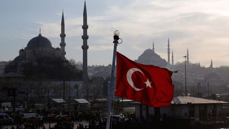 A Turkish flag, with the New and the Suleymaniye mosques in the background, flies on a passenger ferry in Istanbul, Turkey, April 11, 2019. REUTERS/Murad Sezer - RC1B6C6E4270
