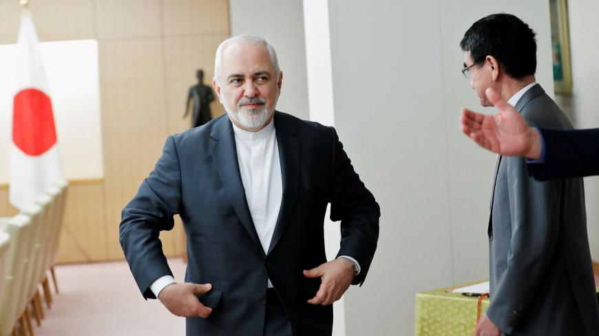 Iranian Foreign Minister Mohammad Javad Zarif (L) is guided to his seat as he meets Japanese Foreign Minister Taro Kono in Tokyo, Japan, May 16, 2019.   REUTERS/Kim Kyung-Hoon - RC1DA976F800