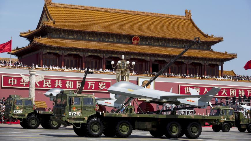 Military vehicles carrying Wing Loong, a Chinese-made medium altitude long endurance unmanned aerial vehicle, travel past Tiananmen Gate during a military parade to commemorate the 70th anniversary of the end of World War II in Beijing Thursday Sept. 3, 2015. REUTERS/Andy Wong/Pool - GF10000191339