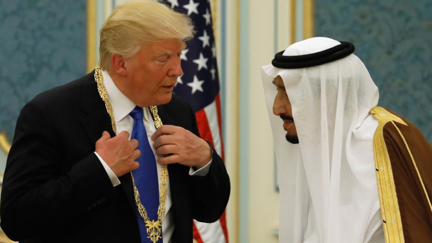 Saudi Arabia's King Salman bin Abdulaziz Al Saud (R) presents U.S. President Donald Trump with the Collar of Abdulaziz Al Saud Medal at the Royal Court in Riyadh, Saudi Arabia May 20, 2017. REUTERS/Jonathan Ernst     TPX IMAGES OF THE DAY - RC18E76205A0