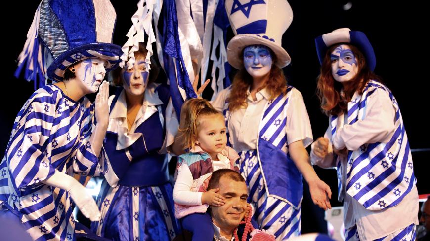 Israelis pose for a picture during celebrations marking Israel's 70th Independence Day in the southern city of Ashkelon, Israel April 18, 2018. REUTERS/Amir Cohen - RC19DBBD8E10