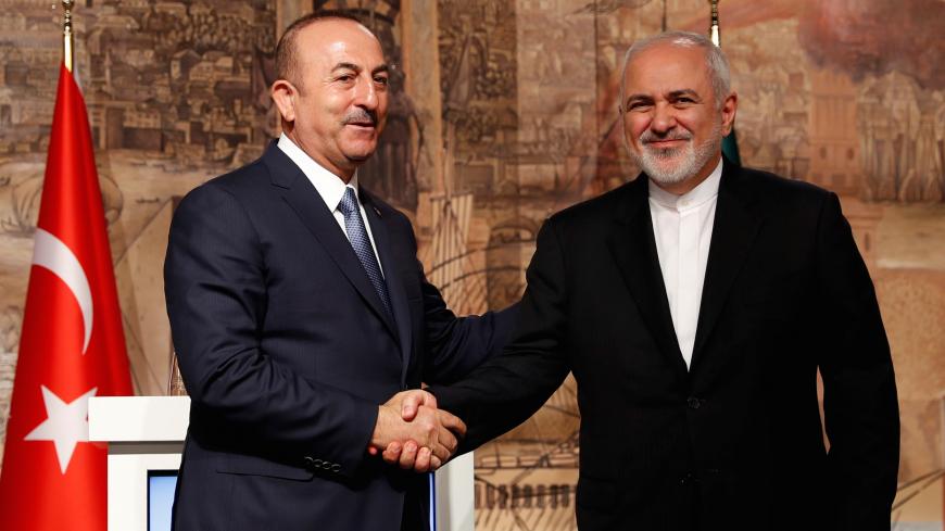 Turkish Foreign Minister Mevlut Cavusoglu shakes hands with his Iranian counterpart Javad Zarif during a news conference in Istanbul, Turkey October 30, 2018. REUTERS/Murad Sezer - RC15CF69EA60