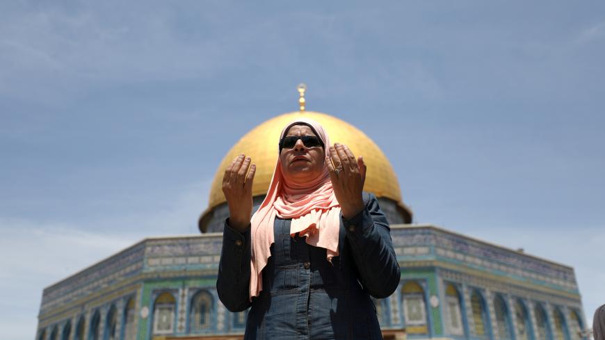 A Palestinian woman prays on the first Friday of the holy fasting month of Ramadan, on the compound known to Muslims as Noble Sanctuary and to Jews as Temple Mount, in Jerusalem's Old City May 10, 2019. REUTERS/ Ammar Awad - RC12461F8A10