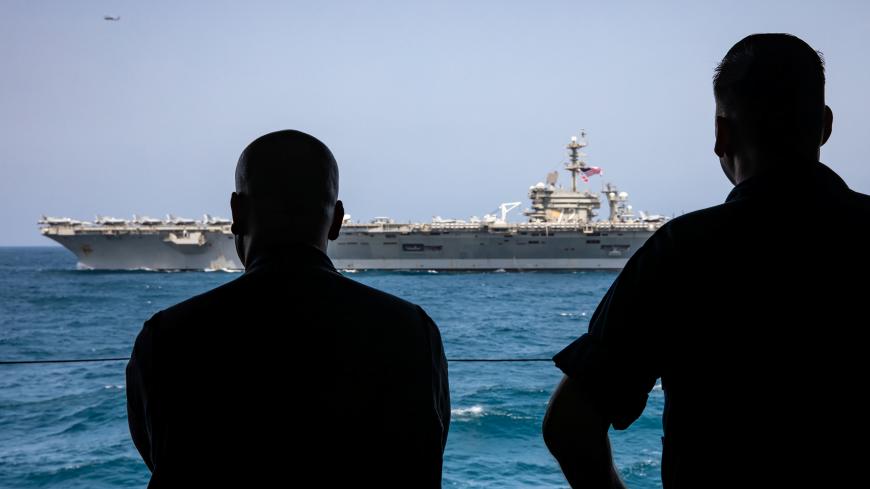 U. S. sailors watch the aircraft carrier USS Abraham Lincoln in Arabian Sea, May 17, 2019. Picture taken May 17, 2019. Nicholas R. Boris/U.S. Navy/Handout via REUTERS ATTENTION EDITORS- THIS IMAGE HAS BEEN SUPPLIED BY A THIRD PARTY. - RC11514055E0