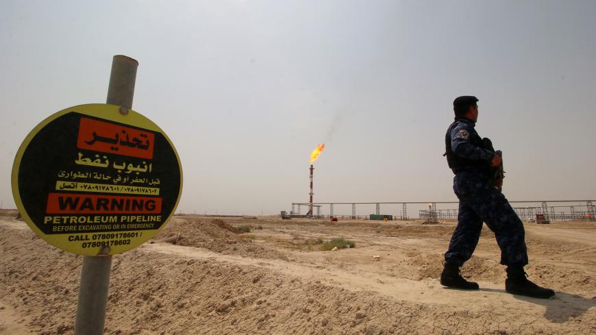 A member of the oil police force guards the entrance of the West Qurna-1 oil field, which is operated by Exxon Mobil, near Basra, Iraq, May 20, 2019. Picture taken May 20, 2019. REUTERS/Essam Al-Sudani - RC17690F9600