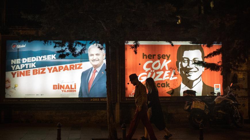 ISTANBUL, TURKEY - JUNE 01: People walk past election posters of AK Parti candidate Binali Yildirim (L) and CHP Party, candidate Ekrem Imamoglu (R) during campaigning in the re-run of the Istanbul mayoral election on June 01, 2019 in Istanbul, Turkey. Imamoglu won a narrow victory during the first mayoral election held in March, defeating the candidate from President Erdogan's Justice and Development Party (AKP). But Turkey‚Äôs election body annulled the result after claims of ‚Äúirregularities,‚Äù and Imam