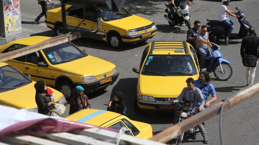 Iranians navigate the traffic in the capital Tehran on the eve of the presidential elections on May 18, 2017. / AFP PHOTO / ATTA KENARE        (Photo credit should read ATTA KENARE/AFP/Getty Images)