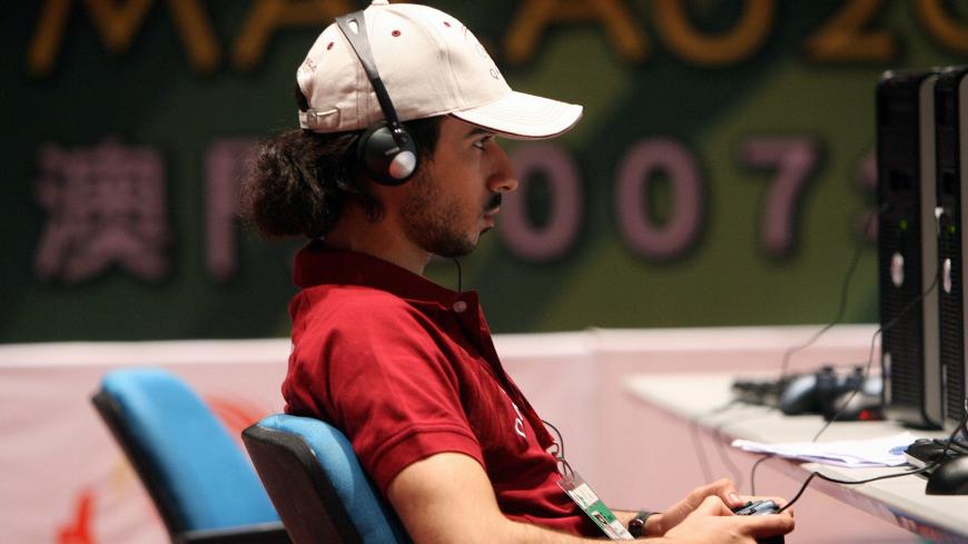 A Qatari player competes in the E-sports competition at the 2nd Asian Indoor Games in Macau, 27 October 2007.   Featuring such unusual events as video games, chess and dance sport, the tournament, now in its second edition, aims to fill the gap left by the Olympics or the Asian Games. AFP PHOTO/Ted ALJIBE (Photo credit should read TED ALJIBE/AFP/Getty Images)