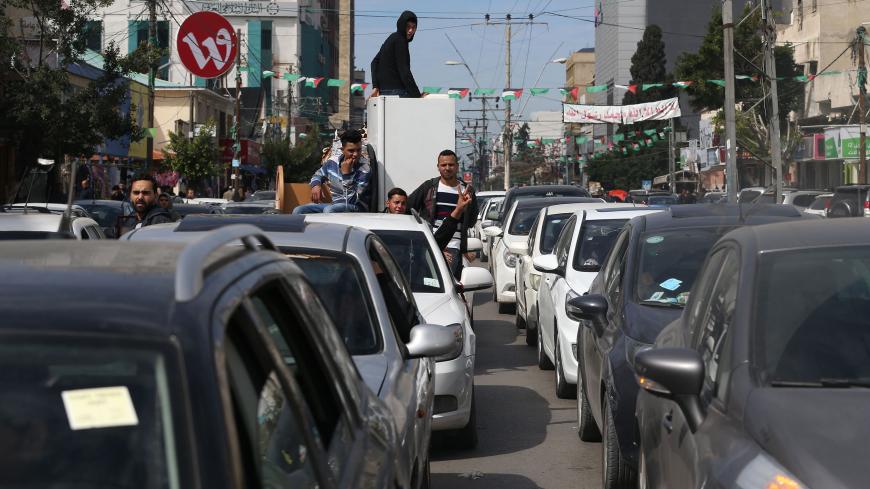 Palestinians stand next to cars in Gaza City on February 20, 2018 during a traffic jam caused by a general strike to protest the humanitarian situation in Gaza.  / AFP PHOTO / MOHAMMED ABED        (Photo credit should read MOHAMMED ABED/AFP/Getty Images)