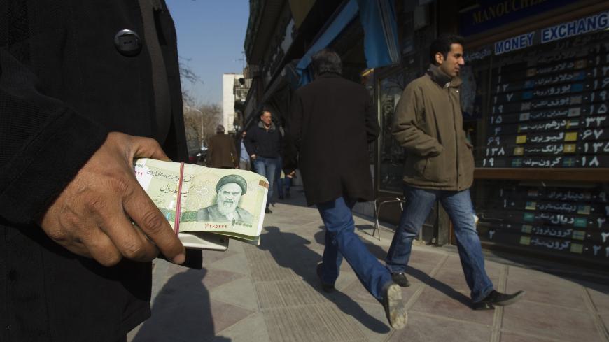 EDITORS' NOTE: Reuters and other foreign media are subject to Iranian restrictions on leaving the office to report, film or take pictures in Tehran.

A money changer holds Iranian rial banknotes as he waits for customers in Tehran's business district January 7, 2012. REUTERS/Raheb Homavandi  (IRAN - Tags: BUSINESS) - GM1E8171GCD01