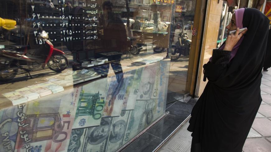 EDITORS' NOTE: Reuters and other foreign media are subject to Iranian restrictions on leaving the office to report, film or take pictures in Tehran.

A woman looks at exchange rates by the window of a currency exchange shop in Tehran's business district January 7, 2012. REUTERS/Raheb Homavandi  (IRAN - Tags: BUSINESS) - GM1E8171GYK01