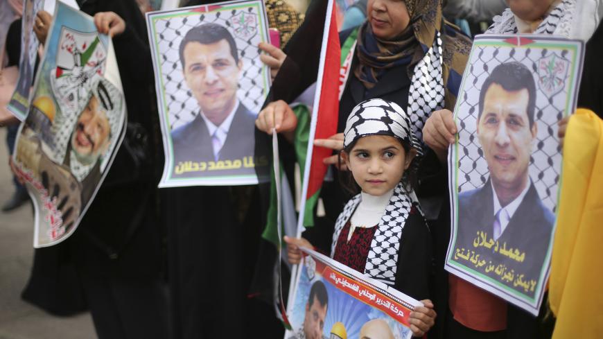 Palestinian supporters of former head of Fatah in Gaza, Mohammed Dahlan, hold posters depicting Dahlan (R) during a protest against Palestinian President Mahmoud Abbas in Gaza City December 18, 2014. Dahlan, who lives in exile in the Gulf, is a powerful political foe of Abbas. 
REUTERS/Mohammed Salem (GAZA - Tags: POLITICS CIVIL UNREST) - GM1EACI1J1501