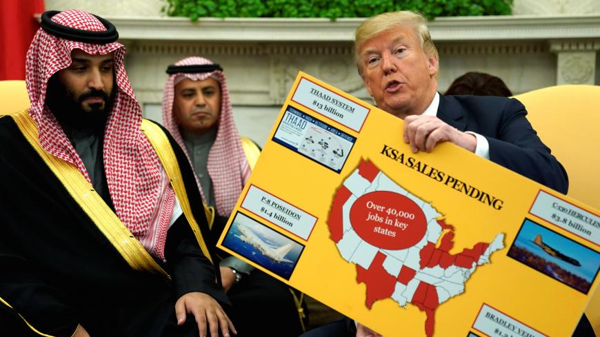 U.S. President Donald Trump holds a chart of military hardware sales as he welcomes Saudi Arabia's Crown Prince Mohammed bin Salman in the Oval Office at the White House in Washington, U.S. March 20, 2018.  REUTERS/Jonathan Ernst - RC14FF352EF0