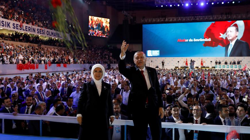 Turkish President Tayyip Erdogan, accompanied by his wife Emine Erdogan, greets his supporters during the sixth Congress of the ruling AK Party (AKP) in Ankara, Turkey, August 18, 2018. REUTERS/Umit Bektas - RC163D352FB0