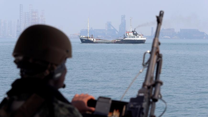 A U.S. Navy soldier onboard Mark VI Patrol Boat stands guard as an oil tanker makes its way towards Bahrain port, during an exercise of U.S./UK Mine Countermeasures (MCMEX) taking place in Arabian Sea, Bahrain September 11, 2018. REUTERS/Hamad I Mohammed - RC1CFA1BB8E0