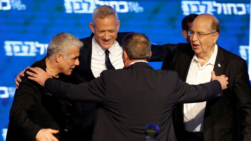 Benny Gantz, head of Blue and White party, prepares to huddle with his party candidates Yair Lapid, Moshe Yaalon and Gaby Ashkenazi, following the announcement of exit polls in Israel's parliamentary election at the party headquarters in Tel Aviv, Israel April 10, 2019. REUTERS/Amir Cohen - RC1129C2DDD0